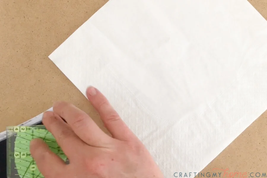 Placing homemade foam stamp on stamp pad next to napkin. 