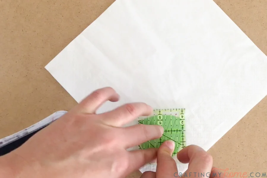 Placing the stamp on the corner of the disposable napkin. 