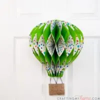 Hot air balloon decor hanging on a white 6 panel door.