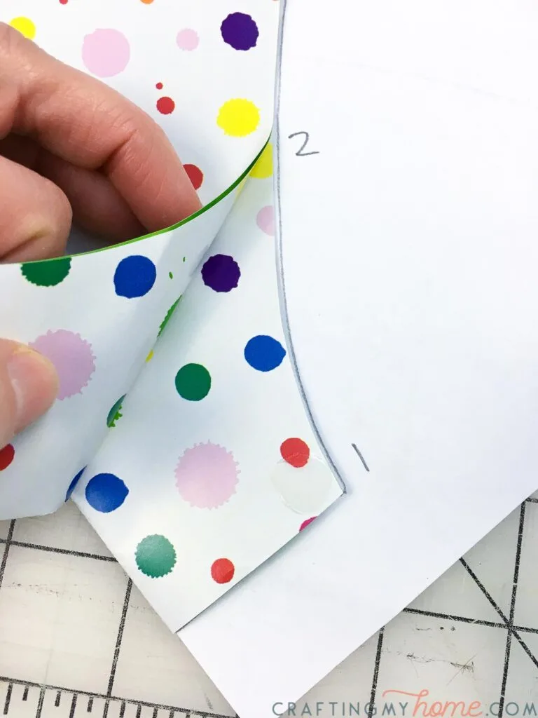 Securing the pieces together with glue dots next to the numbers. 