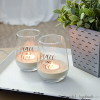 Concrete candle holders for tea lights made from stemless wine glasses on a tray.
