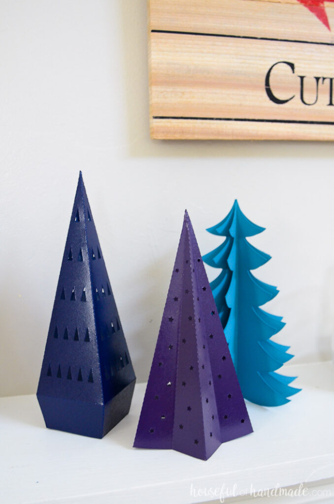 Three decorative Christmas trees made from paper and painted. 