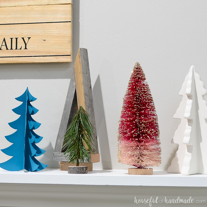 Variety of table top Christmas trees on a mantel.