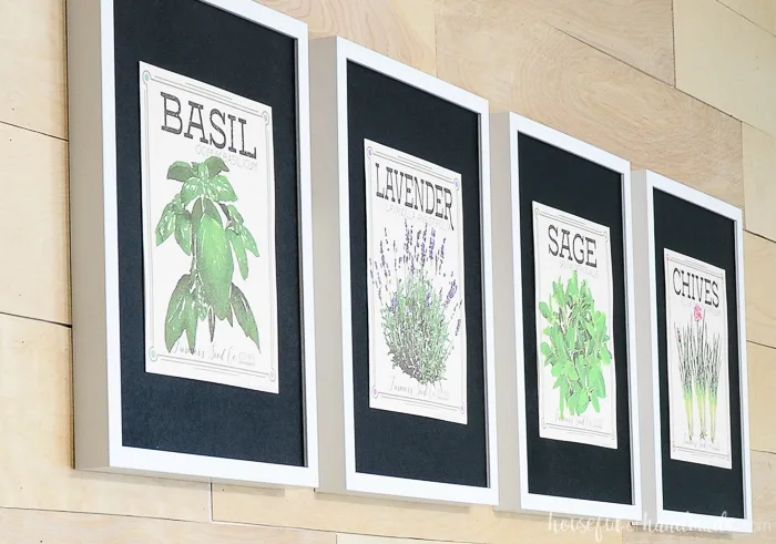 close up of vintage inspired herb prints hanging on wall