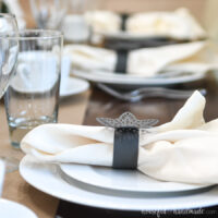 Detailed view of the snowflake paper napkin rings on the papercraft winter tablescape.
