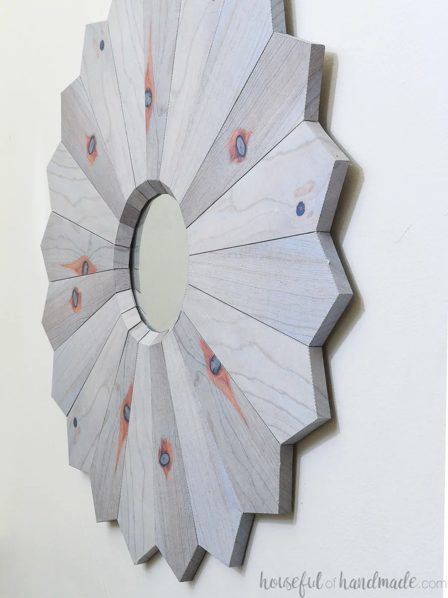 Sideways view of the 3D paper wall mirror that looks like a wood sunburst mirror.