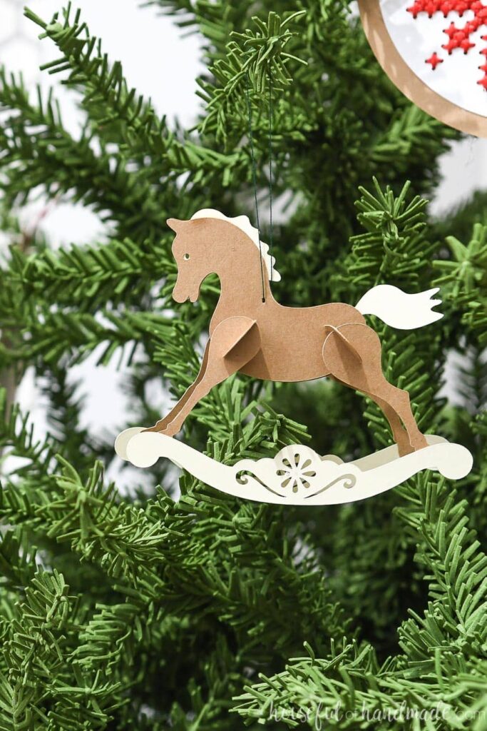 close up of paper rocking horse on tree