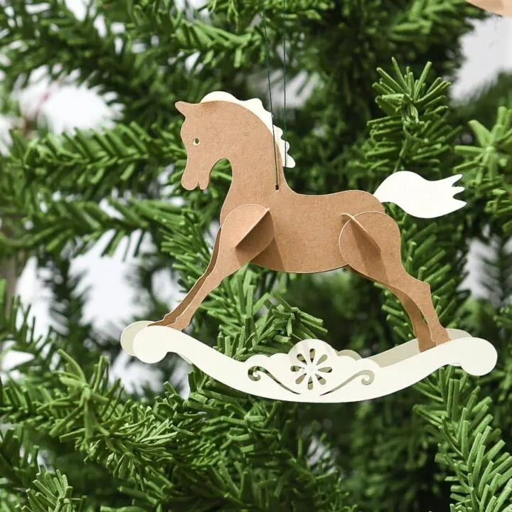 close up of paper rocking horse on tree