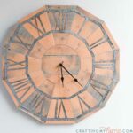 Pallet wood clock made out of paper hanging on the wall.