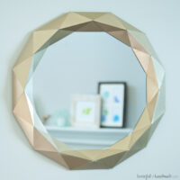 Gold painted Anthropogie knock off mirror made out of paper.