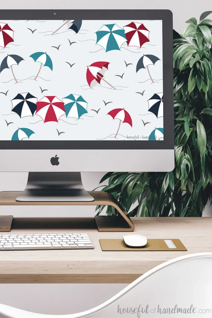 iMac computer with red, white and blue striped umbrella print digital wallpaper on the screen.