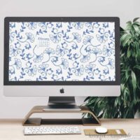 iMac computer on a desk with the blue floral free digital background for February on the screen.