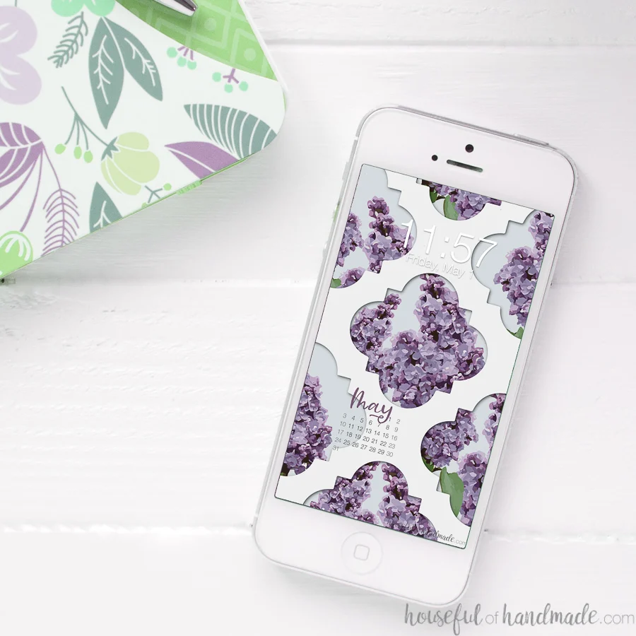 Smartphone with the lilac digital wallpaper on the home screen. 