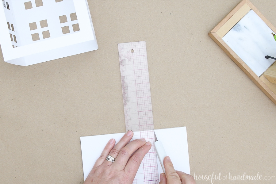 Cutting out a square for the bottom with an x-acto knife and ruler.