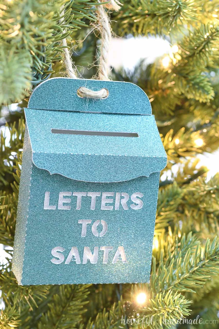 Close up of the green Santa mailbox paper Christmas ornament. 