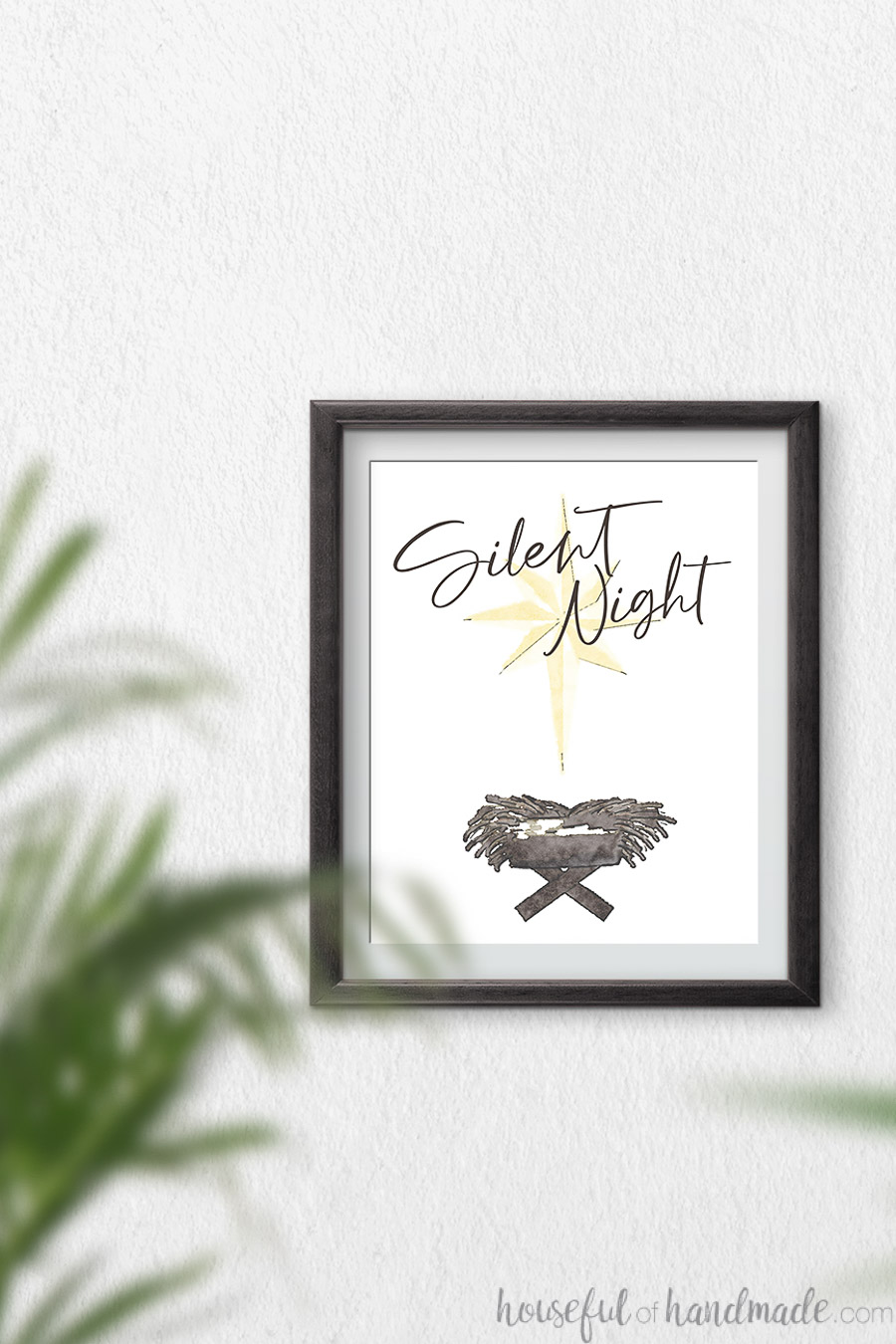 Watercolor Christmas printable of gold star over manger with script Silent Night over it. 