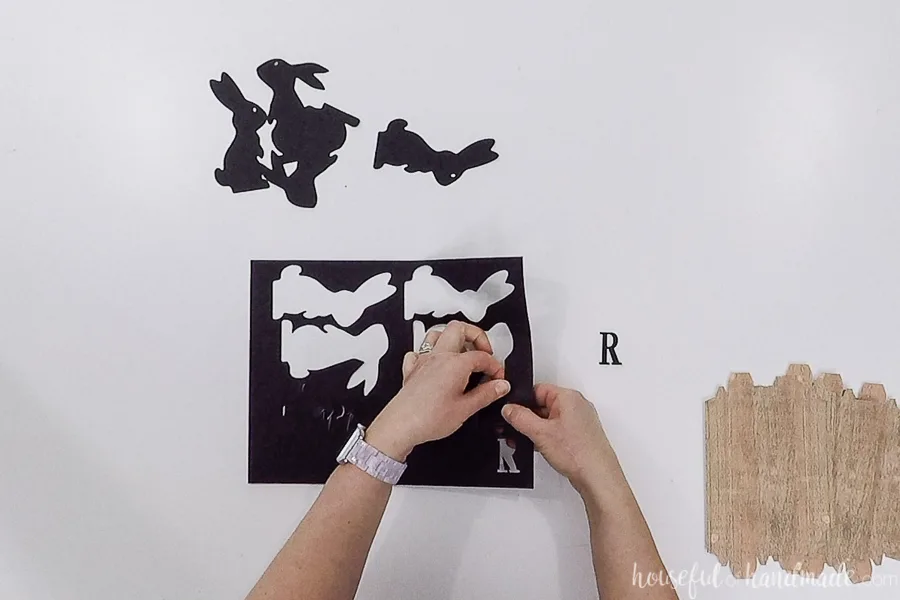 Removing the black pieces for the Easter signs from the paper after being cut with a Silhouette Cameo.