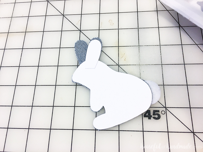 Glueing the cardstock to the back of the finished denim bunny. 