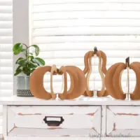 3D paper pumpkin lantern craft for adults on a console table.