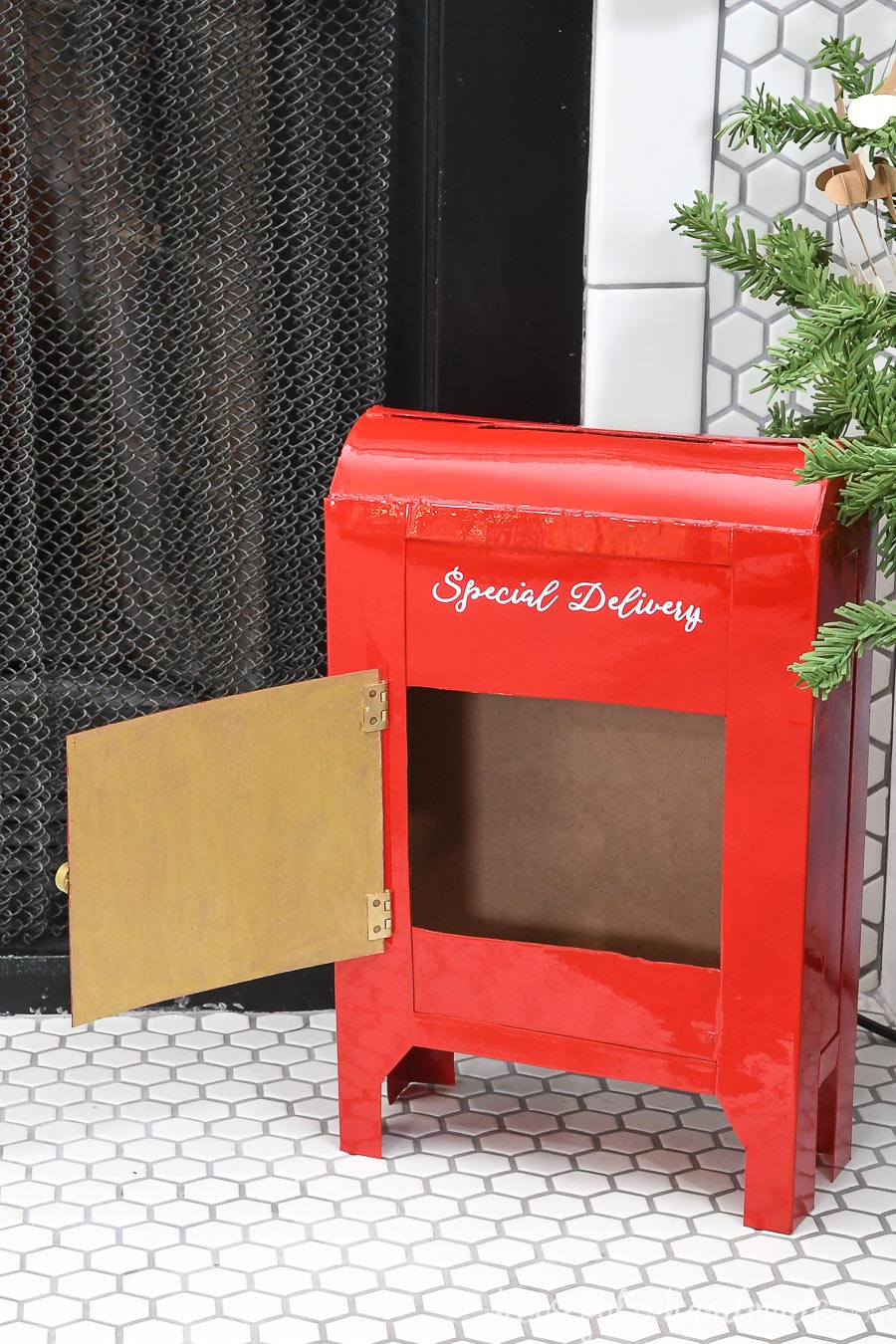 Santa's mailbox DIY with the front door open showing how to remove the letters. 