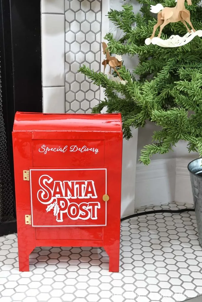 DIY Santa Mailbox made from empty cereal boxes sitting on the fireplace hearth. 