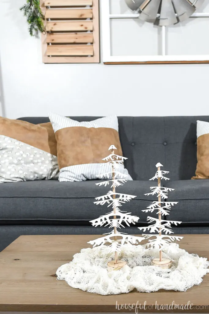 set of 2 completed paper christmas trees on table in front of couch