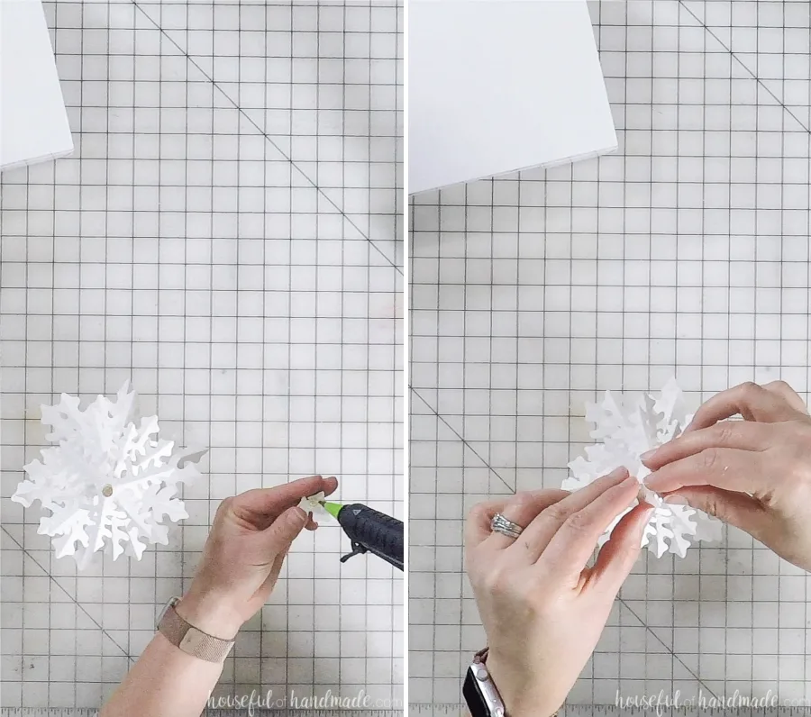 assembling paper christmas trees with hot glue gun to dowel