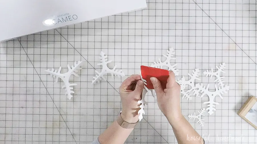 assembling cut out paper christmas trees with straight edge