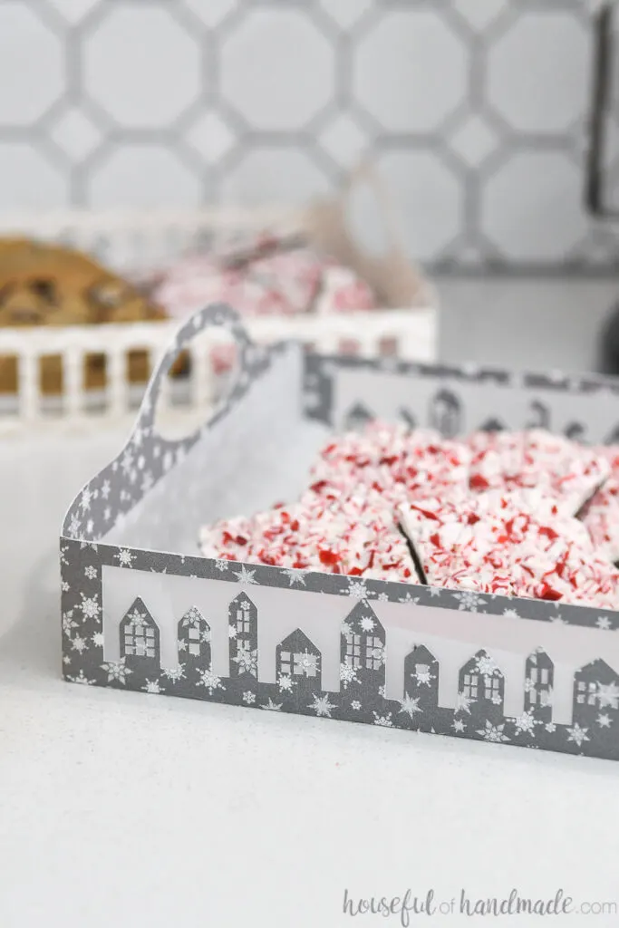 set of 2 paper christmas cookie trays filled with cookies on counter