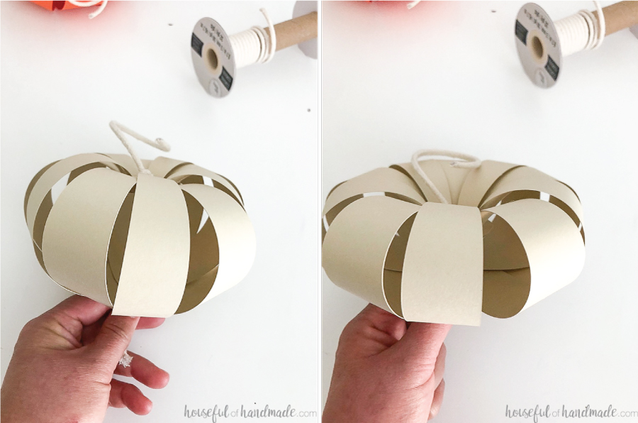 Two pictures of the assembled paper pumpkins showing how you can change the shape by pulling the string tighter. 