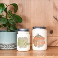 Two DIY kitchen canisters for fall made from upcycled glass jars.