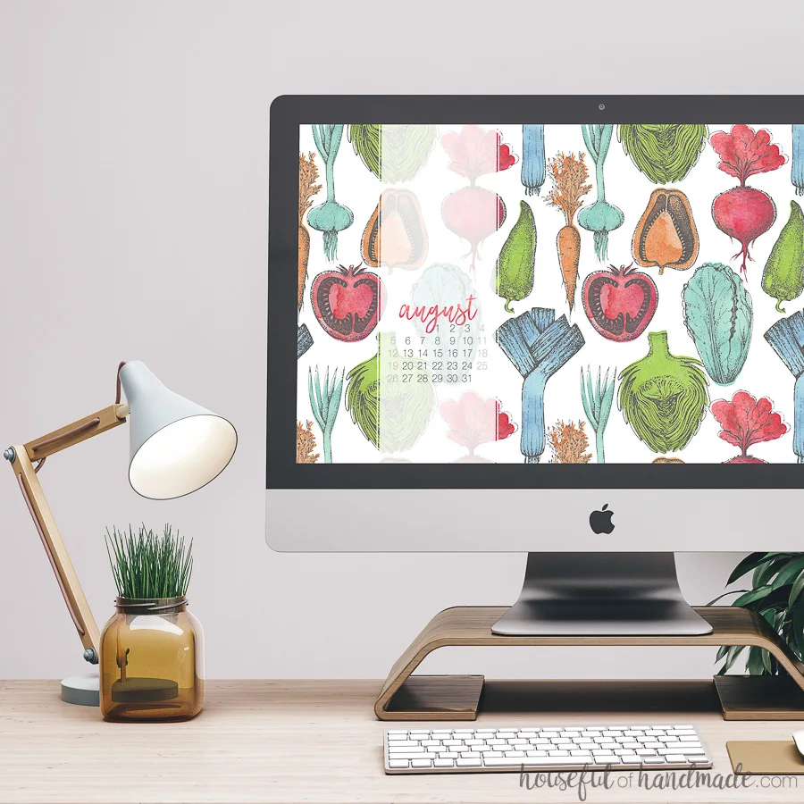 Bring the farmers market to your screens with these beautiful free digital backgrounds for August. The watercolor vegetable pattern is the perfect way to decorate your electronics for the last days of summer. #digitalbackground #digitalwallpaper #vegetableart #freedownload iMac desktop computer with free digital backgrounds for August on it. Watercolor vegetable pattern with blue, green, orange and red, designs.