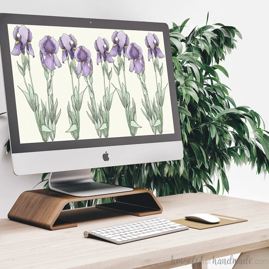 Desktop computer with iris digital background on the screen.