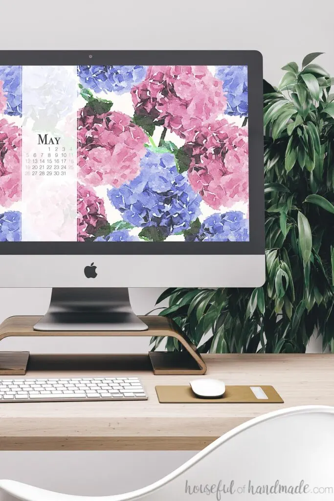 Computer with free digital backgrounds for May on the screen with May 2019 calendar.