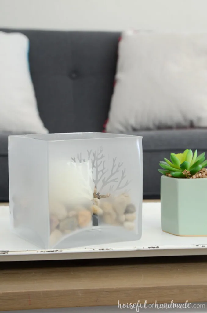 glass candle holder for spring on table with succulent