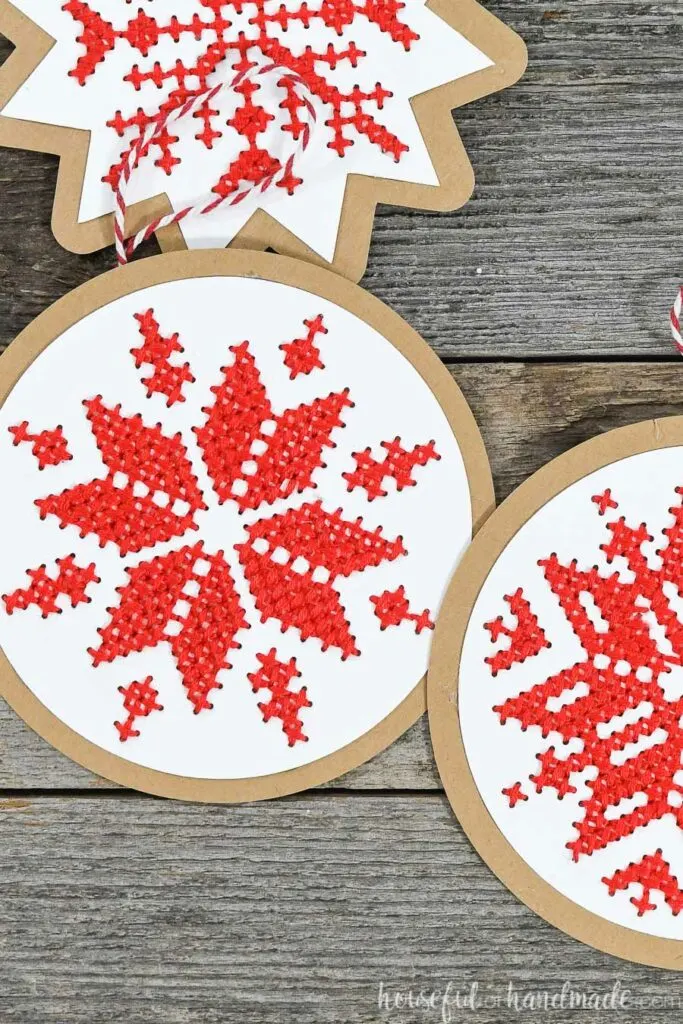 close up of nordic cross stitch ornaments on wood background