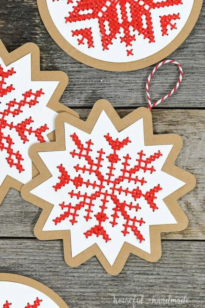 nordic cross stitch Christmas ornaments on wood background