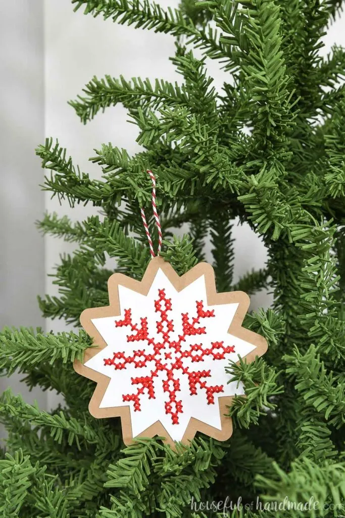 nordic cross stitch ornament hanging on Christmas tree