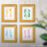 Four frames with printable aspen tree art on a wall