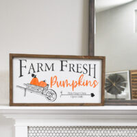Fall wood sign with pumpkin patch vinyl design on it sitting on a mantel.