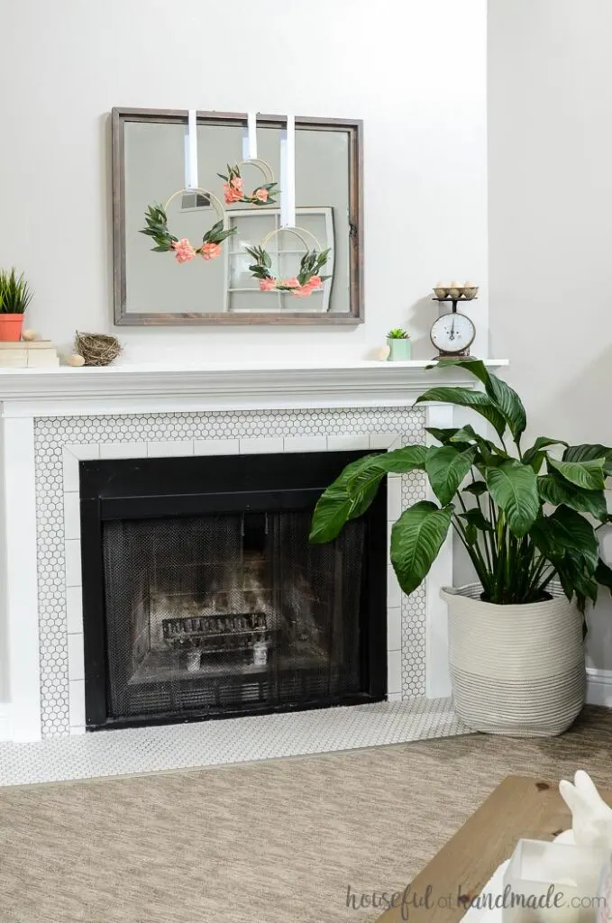 fireplace mantel decorated for spring with hoop wreaths