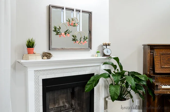 fireplace mantel decorated for spring with spring hoop wreaths