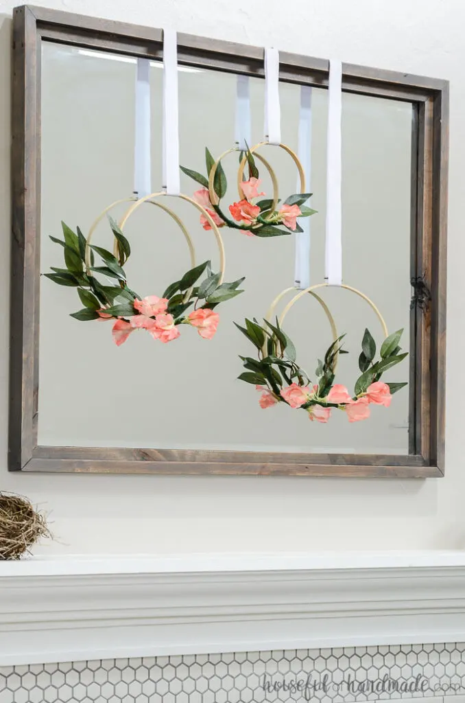 3 spring hoop wreaths on mirror over mantel