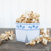Paper cup designed to look like a china tea cup filled with chai spiced caramel popcorn.