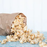 Chewy Peanut Butter Caramel Popcorn in brown bag