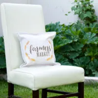 Chair sitting in the yard with decorative pillow made from a printable on the front.