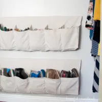 Two hanging shoe storage with rows of pockets sewn from a drop cloth.