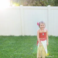 Little girl wearing DIY moana costume in the backyard.