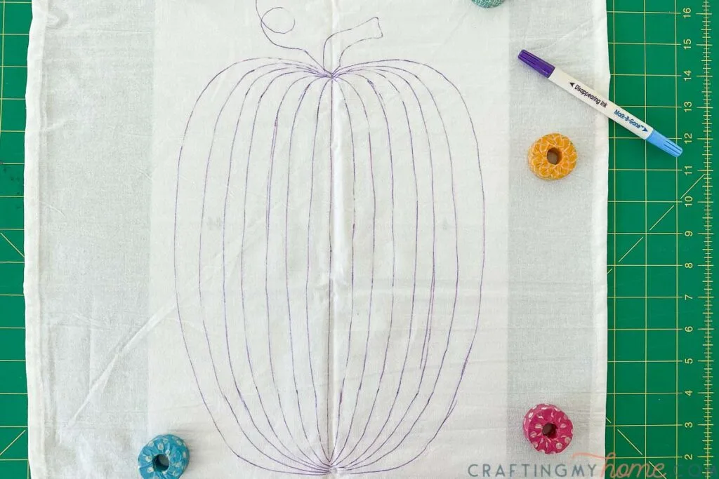 Pumpkin design completely traced onto the tea towel with a purple disappearing fabric marker. 