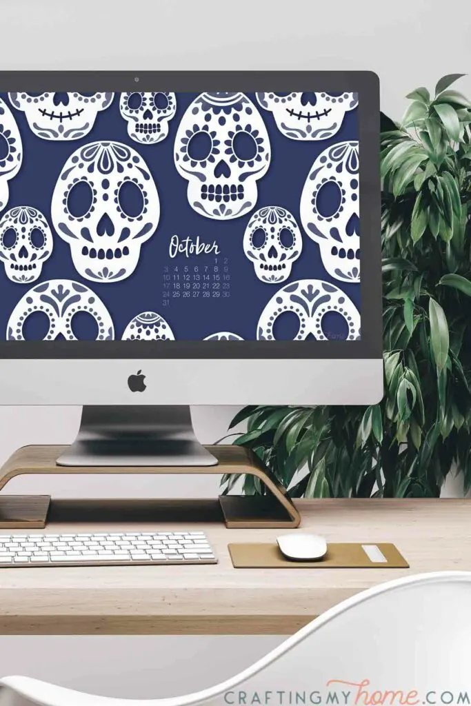Desktop computer showing the sugar skull free digital wallpaper for October on the screen. 
